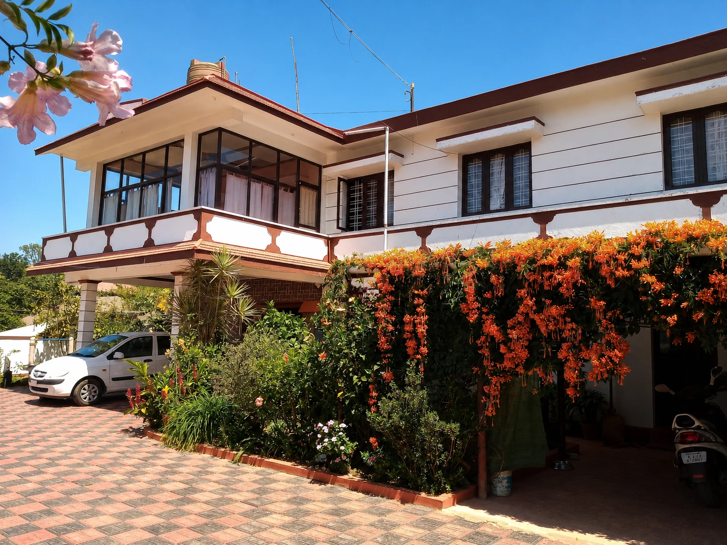 Saboath Homestay exterior framed by flowers